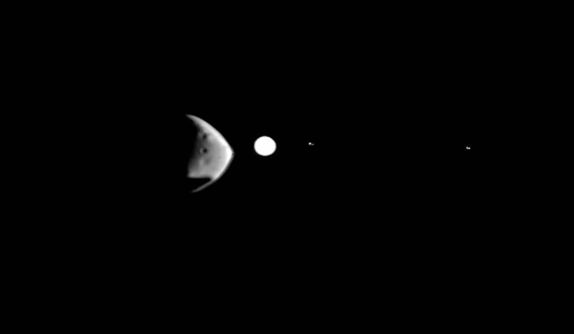 an-illustrated-scene-depicting-the-mars-moon-deimos-obscuring-jupiter