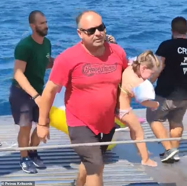 32340362-8660379-She_was_scooped_up_into_the_arms_of_one_of_the_ferry_s_crew_befo-a-1_1598318557698.jpg